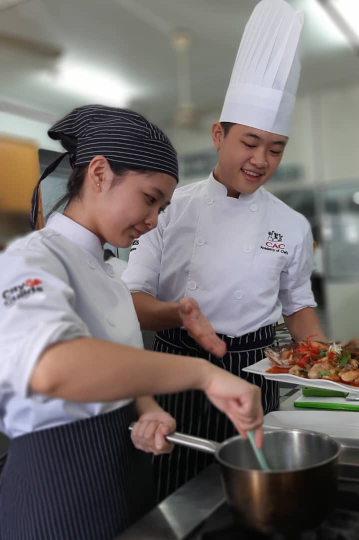 CAC students training in the kitchen with chef guidance